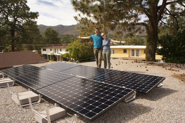 Two people standing in front of solar array