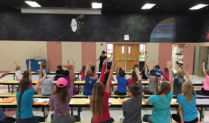 Kids in Class Raising Hands