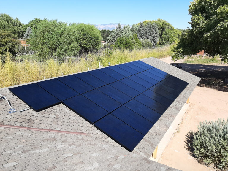 clean solar panels installed on an asphalt shingle roof in Los Ranchos de Albuquerque